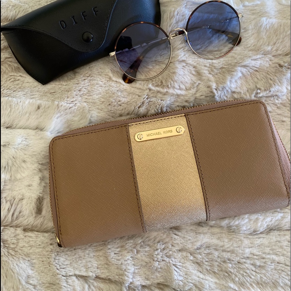 Michael Kors tan with gold zip around wallet.